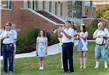 Photo of the bugle being played at an Independence Day flag-raising ceremony at Bel Air Town Hall